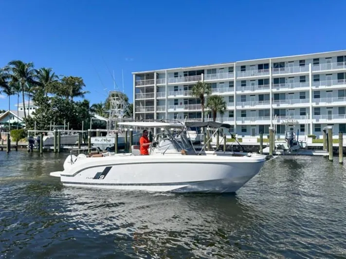  Yacht Photos Pics 2024 Beneteau Flyer 9 SPACEdeck boat cruising near waterfront building.