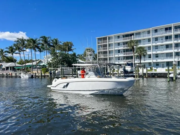  Yacht Photos Pics 2024 Beneteau Flyer 9 SPACEdeck boat on water near waterfront buildings and palm trees.