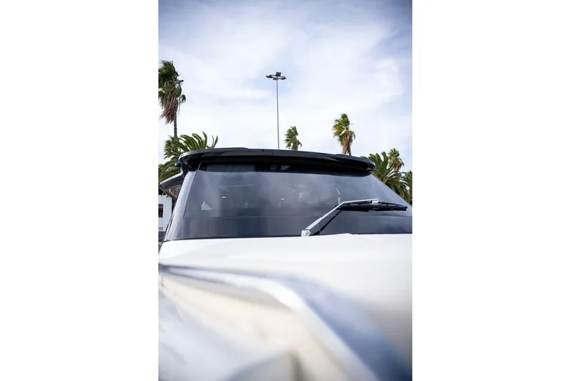  Yacht Photos Pics 2026 Solaris Power 44 Sport Turismo yacht with sleek design and palm trees in background.