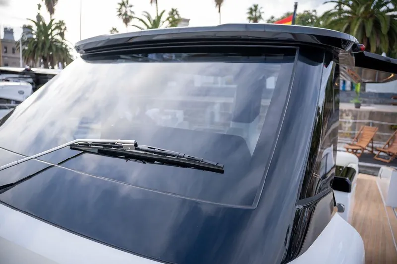  Yacht Photos Pics 2026 Solaris Power 44 Sport Turismo yacht windshield with sleek design and palm trees in background.