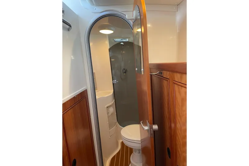 On The Fly Yacht Photos Pics Bathroom interior of 2005 PDQ 34 Power Catamaran with wooden cabinetry and compact design.