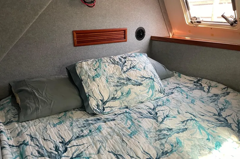 On The Fly Yacht Photos Pics Cozy cabin interior of 2005 PDQ 34 Power Catamaran with patterned bedding.
