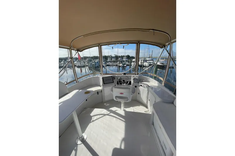 On The Fly Yacht Photos Pics 2005 PDQ 34 Power Catamaran helm with marina view, featuring spacious seating and navigation equipment.