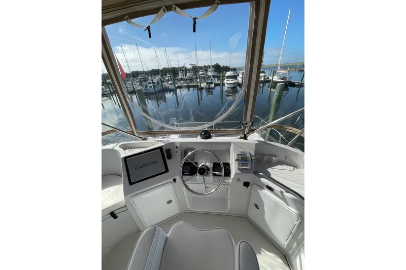 On The Fly Yacht Photos Pics 2005 PDQ 34 Power Catamaran helm with Garmin display, overlooking marina.