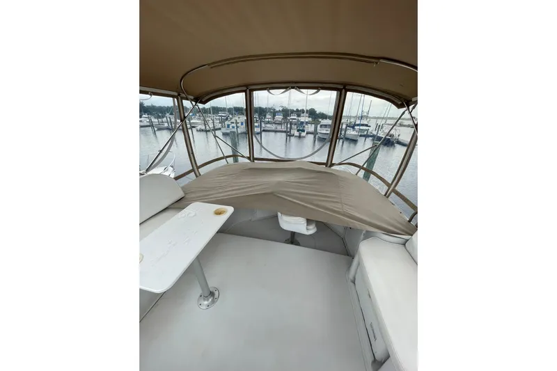 On The Fly Yacht Photos Pics 2005 PDQ 34 Power Catamaran interior with covered seating and marina view.