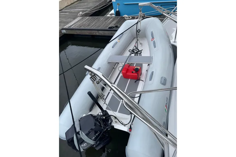 On The Fly Yacht Photos Pics Inflatable dinghy on 2005 PDQ 34 Power Catamaran, docked with outboard motor.