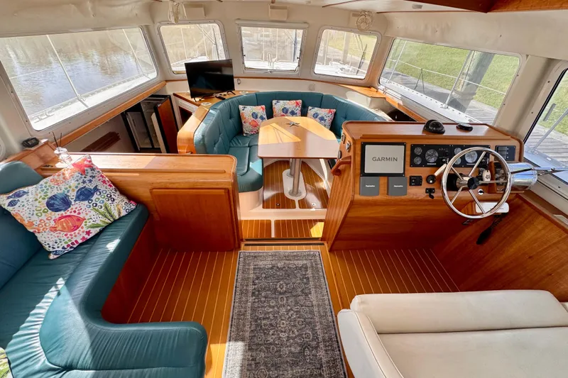 On The Fly Yacht Photos Pics Interior of 2005 PDQ 34 Power Catamaran with cozy seating and modern navigation equipment.