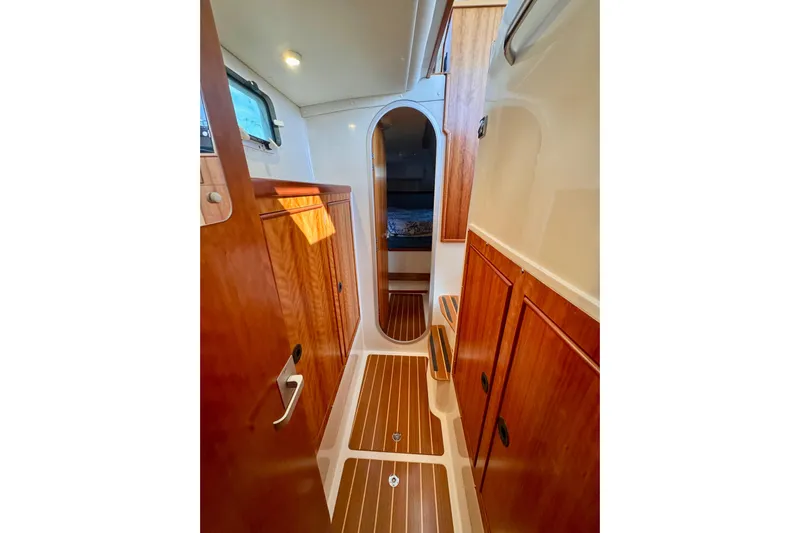 On The Fly Yacht Photos Pics 2005 PDQ 34 Power Catamaran interior with wood finish and cozy cabin view.