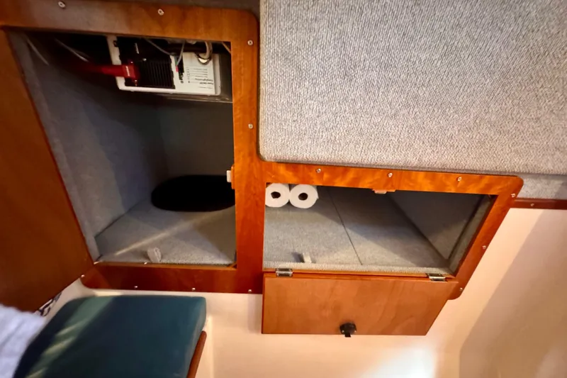 On The Fly Yacht Photos Pics Interior storage compartments on a 2005 PDQ 34 Power Catamaran, featuring wooden cabinetry.