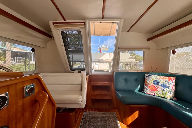 On The Fly Yacht Photos Pics Interior of 2005 PDQ 34 Power Catamaran with seating and nautical decor.