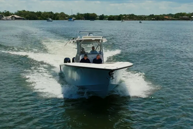  Yacht Photos Pics 2021 SeaVee 390Z boat cruising on a calm lake with passengers onboard.