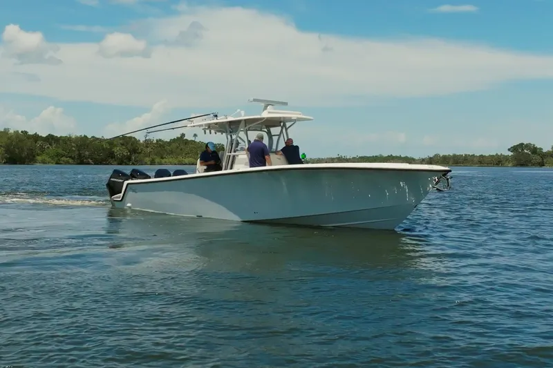  Yacht Photos Pics 2021 SeaVee 390Z boat cruising on a calm lake under a clear blue sky.
