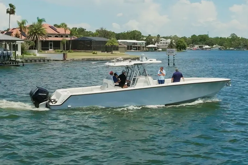  Yacht Photos Pics 2021 SeaVee 390Z boat cruising on a sunny day near waterfront homes.