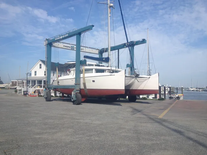 Rollercoaster Yacht Photos Pics 2007 Lagoon 420 catamaran on a boat lift at the harbor.