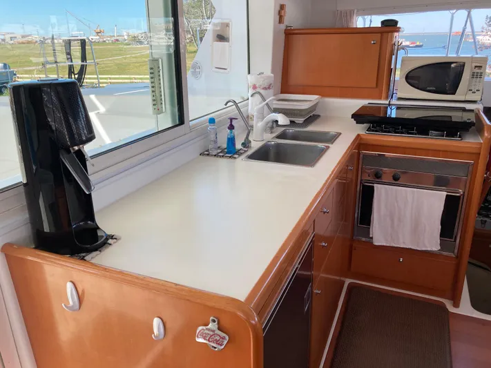 Rollercoaster Yacht Photos Pics Lagoon 420 catamaran kitchen, 2007 model, featuring appliances and sink.