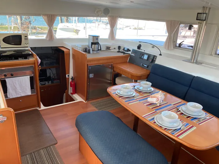 Rollercoaster Yacht Photos Pics Interior of a 2007 Lagoon 420 yacht with dining area and kitchen.