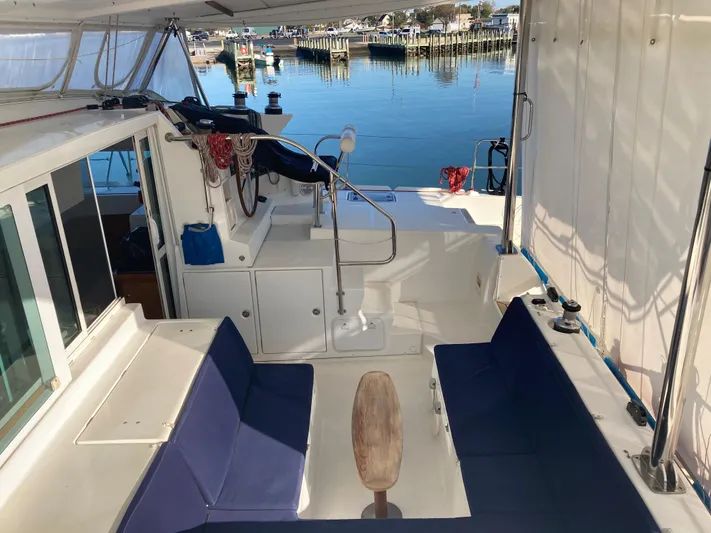 Rollercoaster Yacht Photos Pics Interior of a 2007 Lagoon 420 yacht with blue seating cushions.
