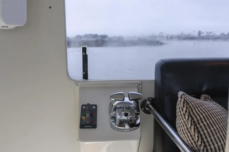 Pole Dancer Yacht Photos Pics Interior of a 2005 Mediterranean 54 yacht with control panel and window view.