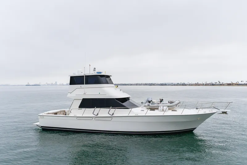 Pole Dancer Yacht Photos Pics Luxury 2005 Mediterranean 54 yacht cruising on calm waters under cloudy skies.