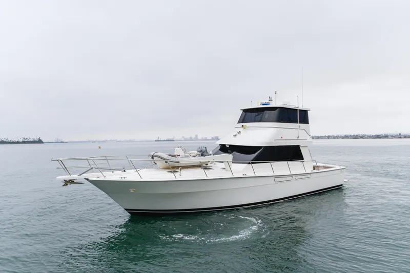 Pole Dancer Yacht Photos Pics 2005 Mediterranean 54 yacht cruising on calm waters under overcast skies.