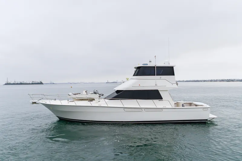 Pole Dancer Yacht Photos Pics 2005 Mediterranean 54 yacht on calm waters under overcast sky.