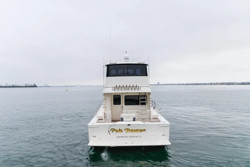 Pole Dancer Yacht Photos Pics 2005 Mediterranean 54 yacht on calm waters, overcast sky, rear view.