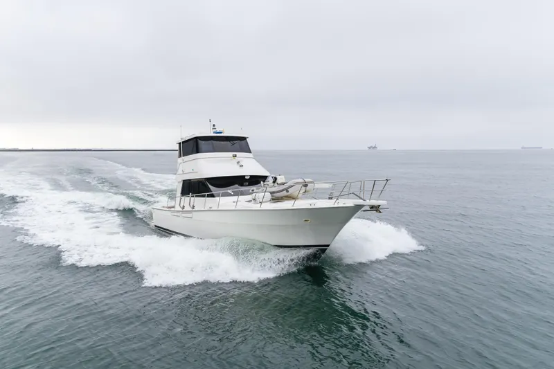 Pole Dancer Yacht Photos Pics 2005 Mediterranean 54 yacht cruising on open sea under cloudy skies.
