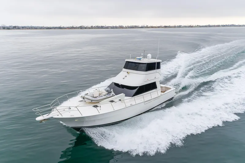Pole Dancer Yacht Photos Pics 2005 Mediterranean 54 yacht cruising on calm waters, creating a dynamic wake.