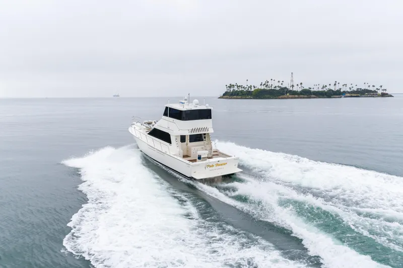 Pole Dancer Yacht Photos Pics 2005 Mediterranean 54 yacht cruising near an island on a cloudy day.