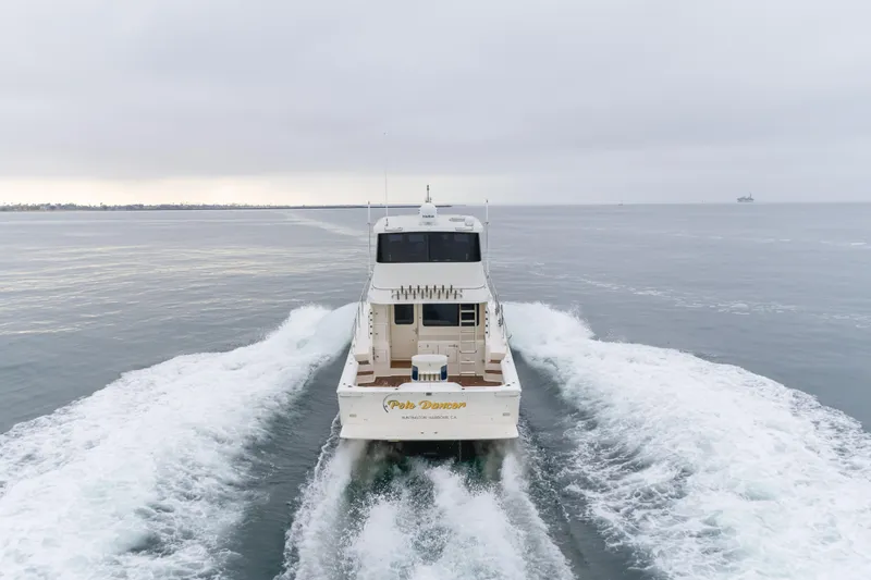 Pole Dancer Yacht Photos Pics 2005 Mediterranean 54 yacht cruising on open water, creating a wake behind.