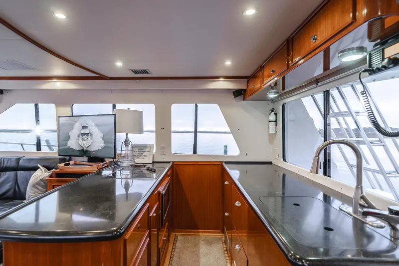 Pole Dancer Yacht Photos Pics Luxurious interior of 2005 Mediterranean 54 yacht with sleek kitchen and panoramic windows.