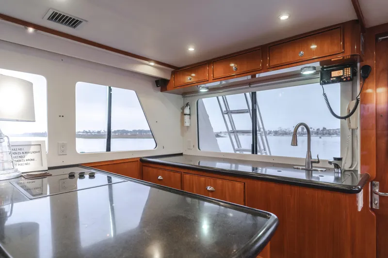 Pole Dancer Yacht Photos Pics Luxurious kitchen interior of 2005 Mediterranean 54 yacht with sleek countertops and ocean view.