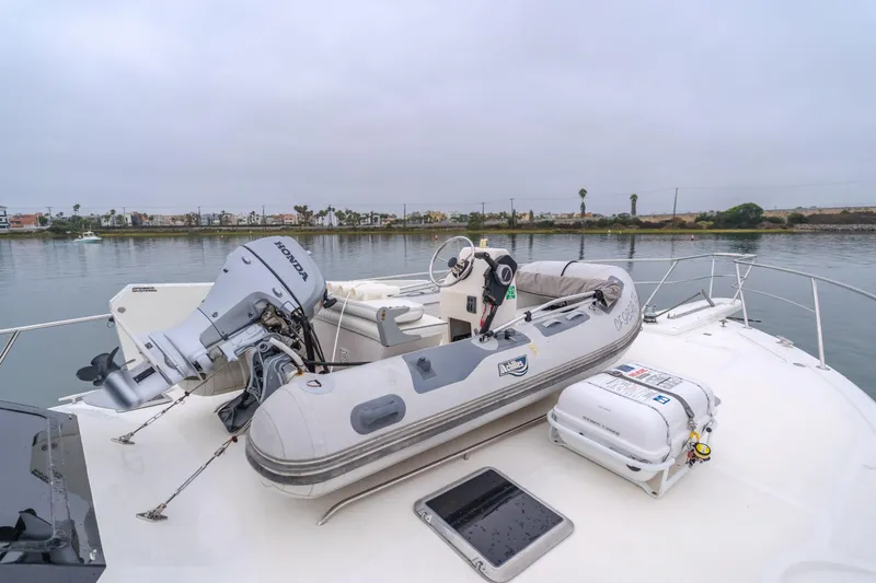 Pole Dancer Yacht Photos Pics 2005 Mediterranean 54 yacht with inflatable boat and Honda motor on deck.