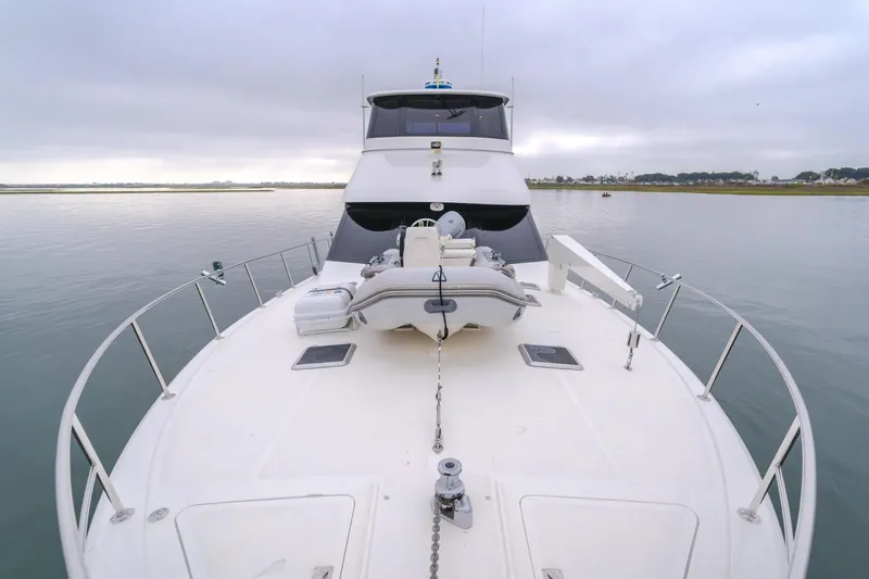 Pole Dancer Yacht Photos Pics Luxury 2005 Mediterranean 54 yacht on calm waters, featuring spacious deck and modern design.