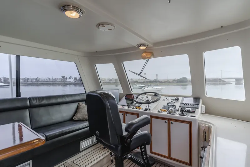 Pole Dancer Yacht Photos Pics Interior of 2005 Mediterranean 54 yacht with helm, seating, and panoramic windows.