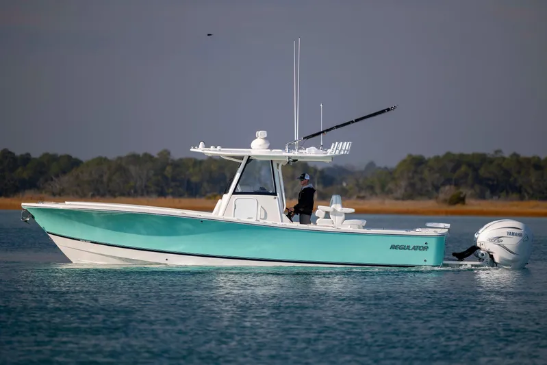  Yacht Photos Pics 2022 Regulator 31 boat on calm water, featuring Yamaha outboard engines.