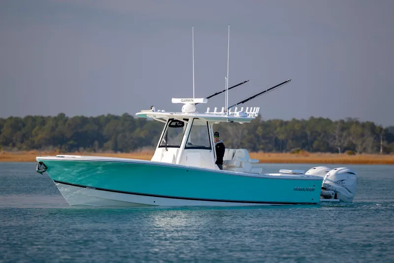  Yacht Photos Pics 2022 Regulator 31 boat on calm water with scenic background.