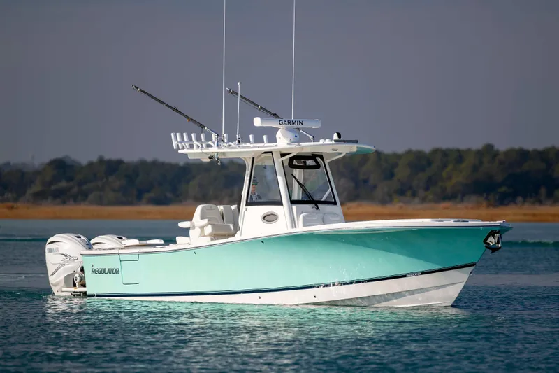  Yacht Photos Pics 2022 Regulator 31 boat on calm water with fishing rods and Yamaha engines.