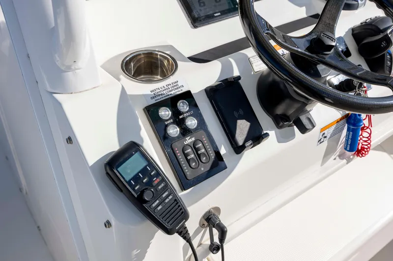  Yacht Photos Pics Control panel of 2022 Regulator 31 boat with steering wheel and communication device.