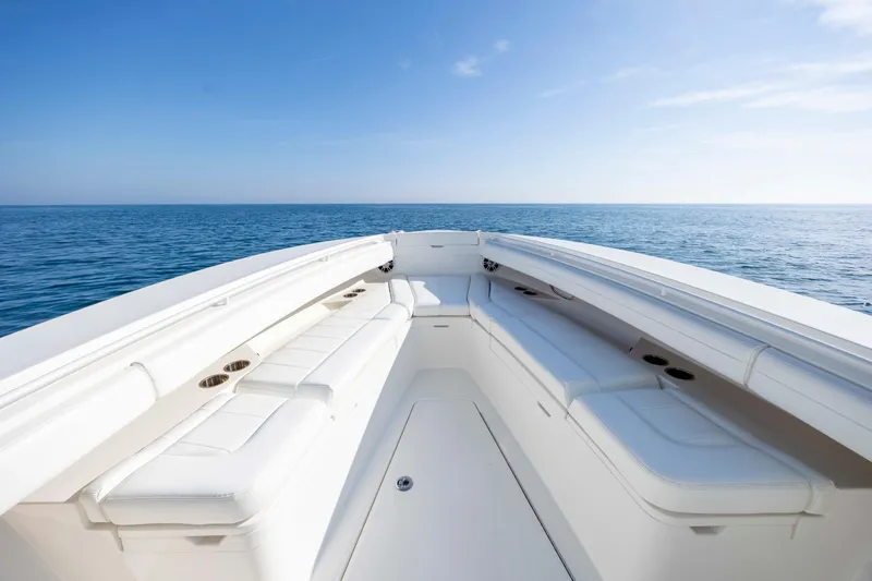  Yacht Photos Pics 2022 Regulator 31 boat interior with white seating, ocean view, and clear blue sky.