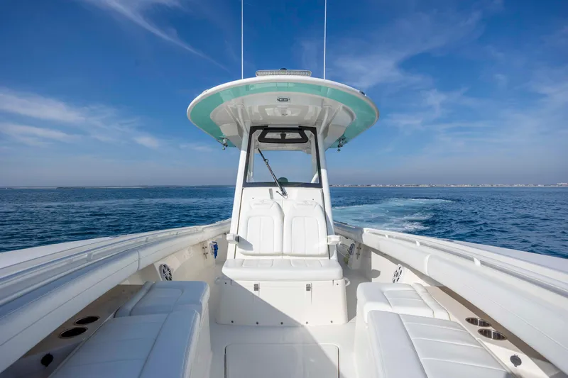  Yacht Photos Pics 2022 Regulator 31 boat cruising on open water under clear blue sky.