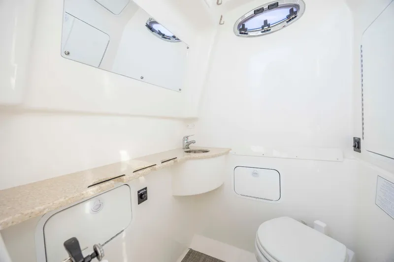  Yacht Photos Pics 2022 Regulator 31 boat interior bathroom with sink and toilet.