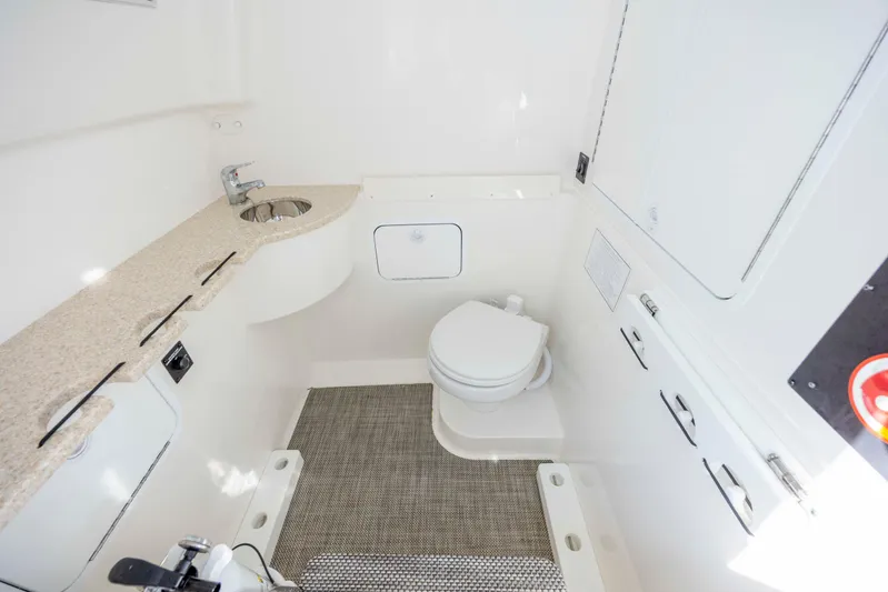  Yacht Photos Pics 2022 Regulator 31 boat interior bathroom with sink, toilet, and storage.