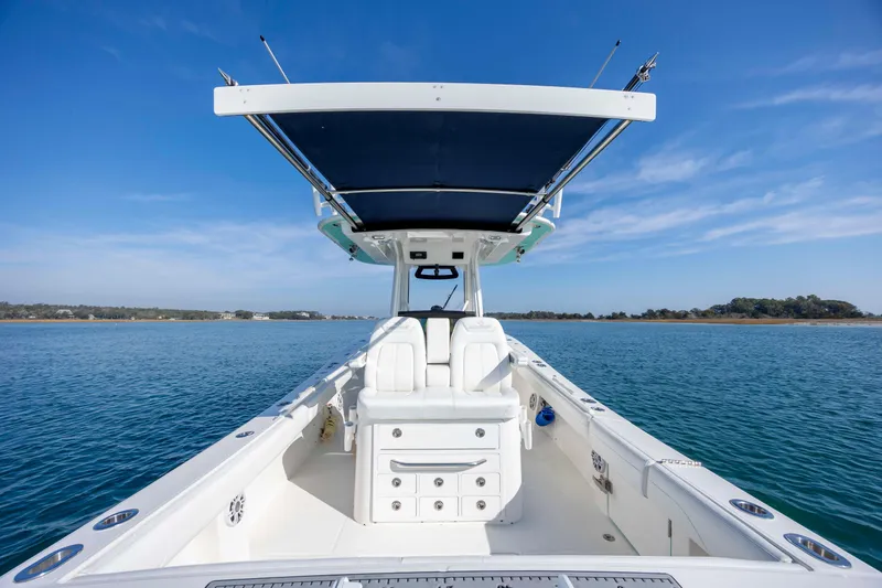  Yacht Photos Pics 2022 Regulator 31 boat on calm water under clear blue sky.