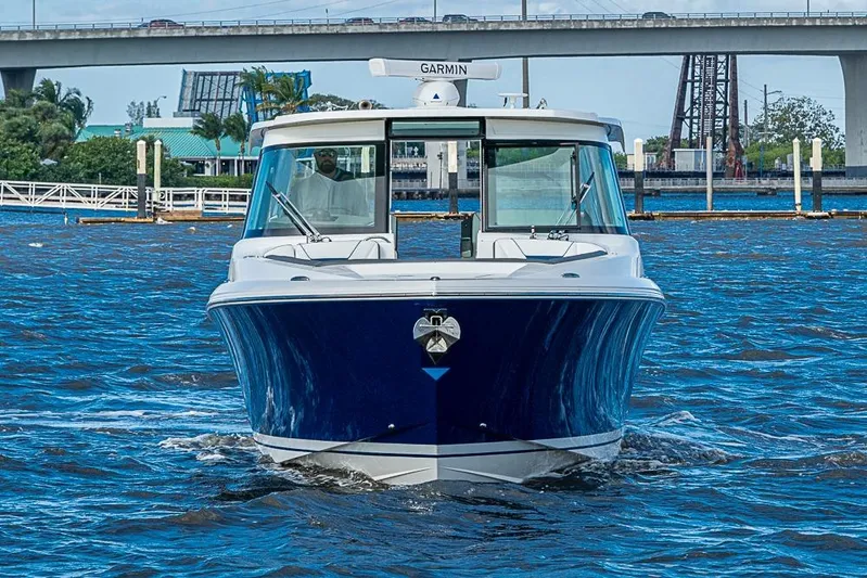 Prawn Star Yacht Photos Pics 2022 Tiara Yachts 34 LX cruising on water with bridge in background.
