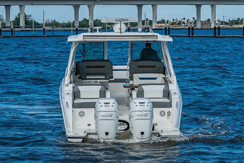 Prawn Star Yacht Photos Pics 2022 Tiara Yachts 34 LX cruising on open water, rear view with dual engines.
