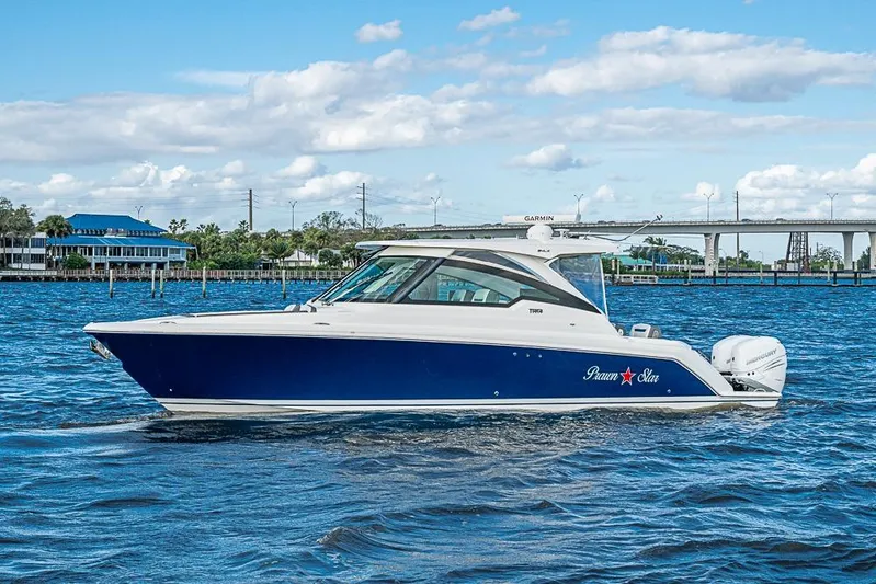 Prawn Star Yacht Photos Pics 2022 Tiara Yachts 34 LX boat cruising on a sunny day with blue skies.