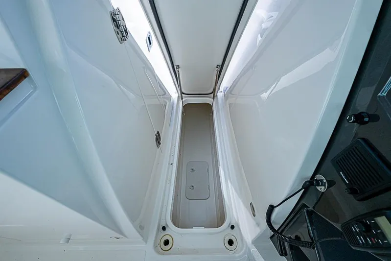 Prawn Star Yacht Photos Pics 2022 Tiara Yachts 34 LX interior storage compartment, sleek white design.