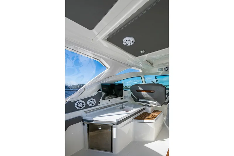 Prawn Star Yacht Photos Pics Interior of 2022 Tiara Yachts 34 LX, featuring helm, seating, and entertainment system.