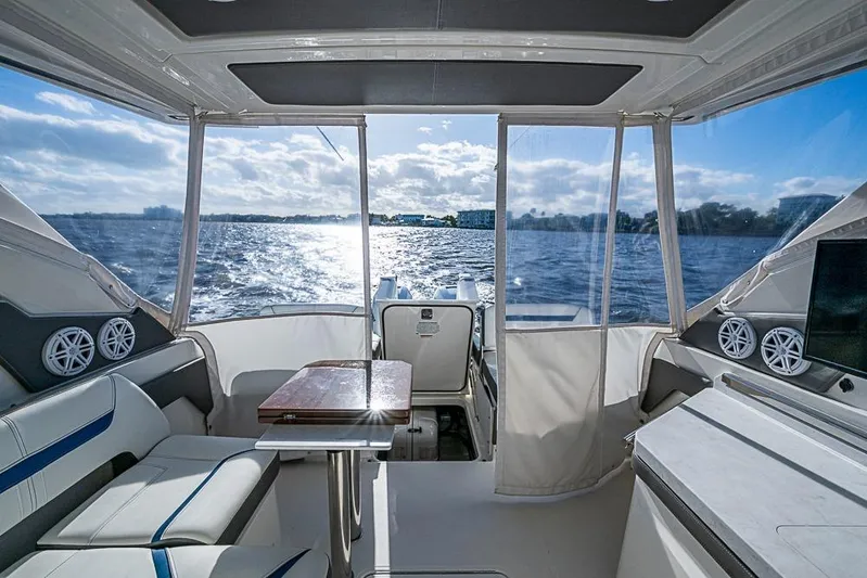 Prawn Star Yacht Photos Pics Interior view of 2022 Tiara Yachts 34 LX, featuring luxurious seating and scenic water backdrop.